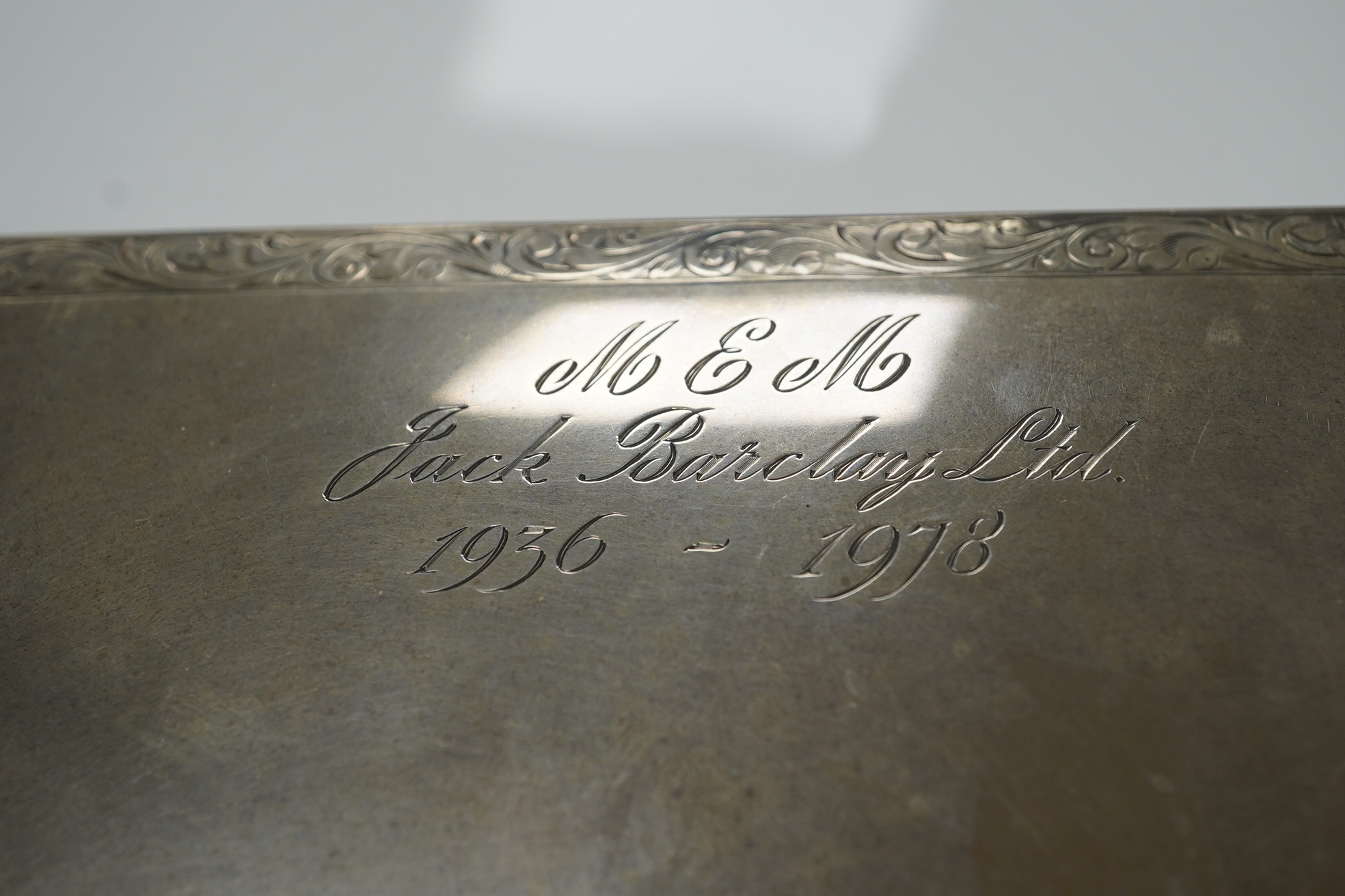 An Elizabeth II silver mounted rectangular cigarette box, with engraved inscription, C.S. Green & Co, Birmingham, 1975, 16.4cm. Condition - poor to fair